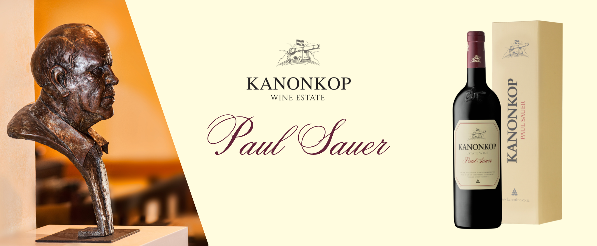 Kanonkop Wine Estate banner featuring a bronze bust sculpture of Paul Sauer alongside a bottle and gift box of the Kanonkop Paul Sauer Estate Wine, with the Kanonkop cannon emblem and estate name at the centre of the design.